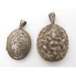 A white metal Anglo Indian locket depicting Ganesh, and a further white metal locket with all over