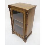 A Victorian mahogany and walnut veneered music cabinet with single glazed door flanked by turned