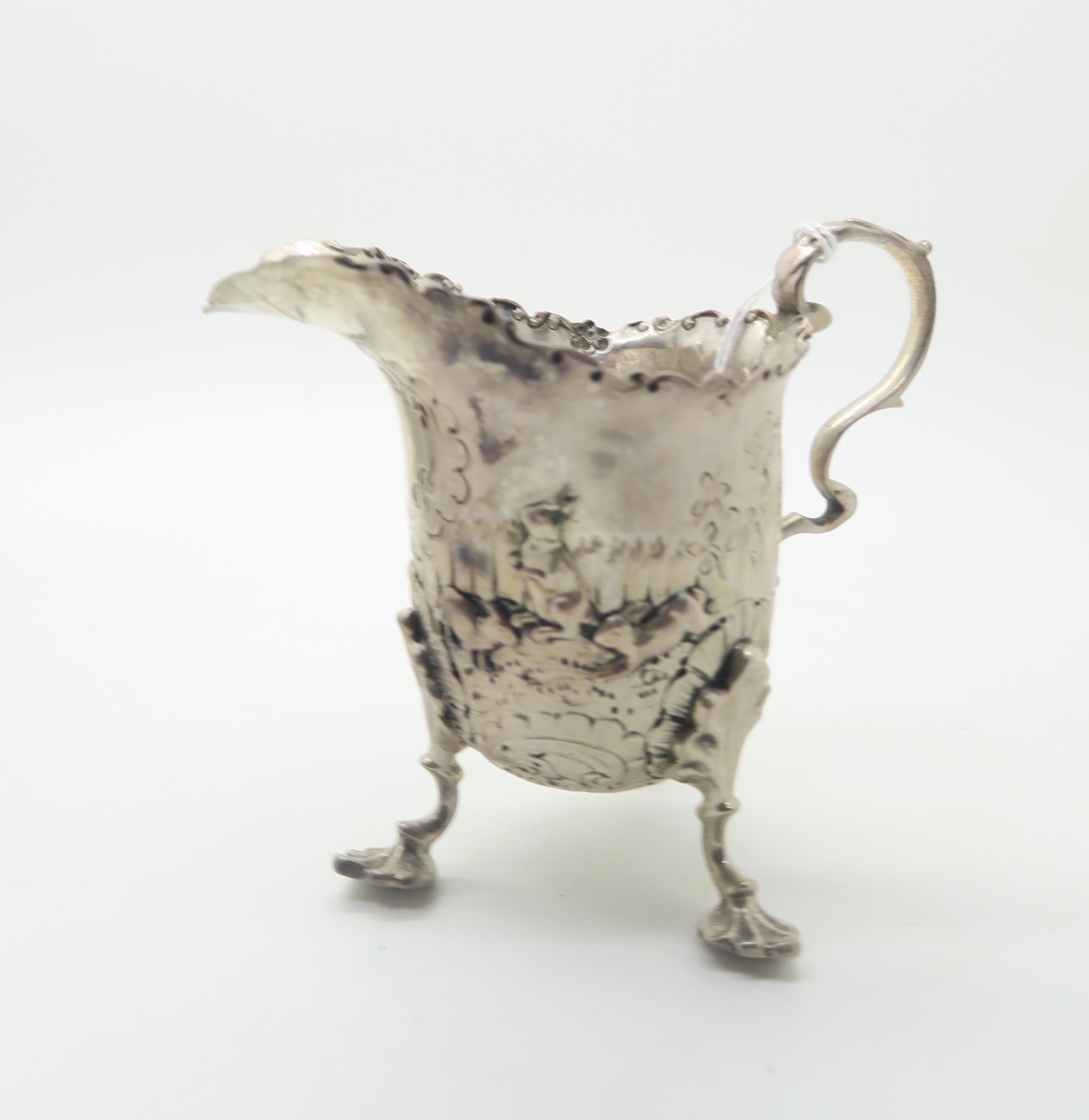 A silver cream jug, with chased and applied decoration of rabbits and birds, with scrolling rim - Image 2 of 6