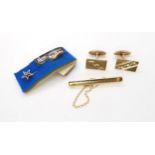 An 18ct gold tie clip set with a diamond, weight 5.5gms, a pair of 9ct gold cufflinks and a 9ct