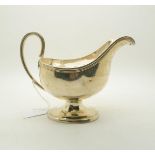 A George III silver sauce boat, with reeded handle and rim, on a stepped oval base, possibly by