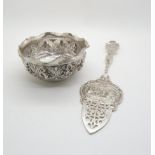 A German silver cake server, the server with pierced floral decoration, the body with repousse