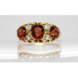 A Liberty and Co 18ct gold garnet and diamond ring, size Q 1/2, weight 3.9gms Condition Report: