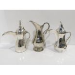 A Persian white metal Dallah coffee pot, with shell thumbpiece, and another, and a white metal