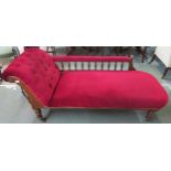 A Victorian oak framed chaise lounge with red upholstery on turned supports Condition Report: