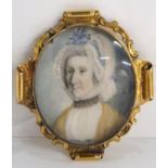 CONTINENTAL SCHOOL PORTRAIT MINIATURE  Lady wearing a ribbon tied lace cap, monogrammed, in gilt