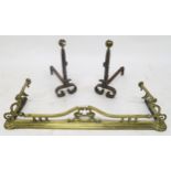 A pair of 19th century wrought iron fire dogs and a brass fire fender (3) Condition Report:Available