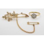 An 18ct diamond cluster ring, size P and a 9ct seed pearl set brooch (missing central pearl) with