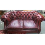 A 20th century oxblood leather upholstered Chesterfield style two seater club sofa, 73cm high x