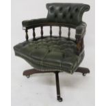 A 20th century mahogany and green leather button upholstered revolving captains desk chair Condition