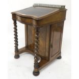 A Victorian walnut Davenport with black leather skiver, barley twist uprights and single cabinet