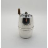 A stamped sterling barrel form pepper grinder, by Cartier, with engraved initials, stamped