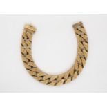 A gold chunky bark effect curb link bracelet, stamped 375, 21cm long,  82.1gms Condition Report: