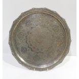 An Iranian silver circular tray, with engraved arabic floral motifs, with applied floral rim,