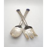 A pair of sterling salad servers, the terminals inset with lapis cabochons, with applied initials