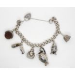 A silver charm bracelet, with six large silver and white metal charms attached Condition Report: