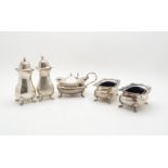 A five piece silver cruet set, comprising two salts, two casters, and a mustard pot, with blue glass
