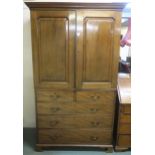 A Victorian mahogany linen press with moulded cornice above two panel doors concealing linen drawers