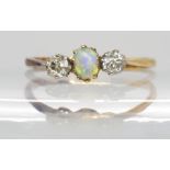 An 18ct and platinum diamond and opal three stone ring, approx .20 cts of diamonds Condition