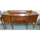 A 20th century mahogany sideboard with two central drawers flanked by cabinet doors on square