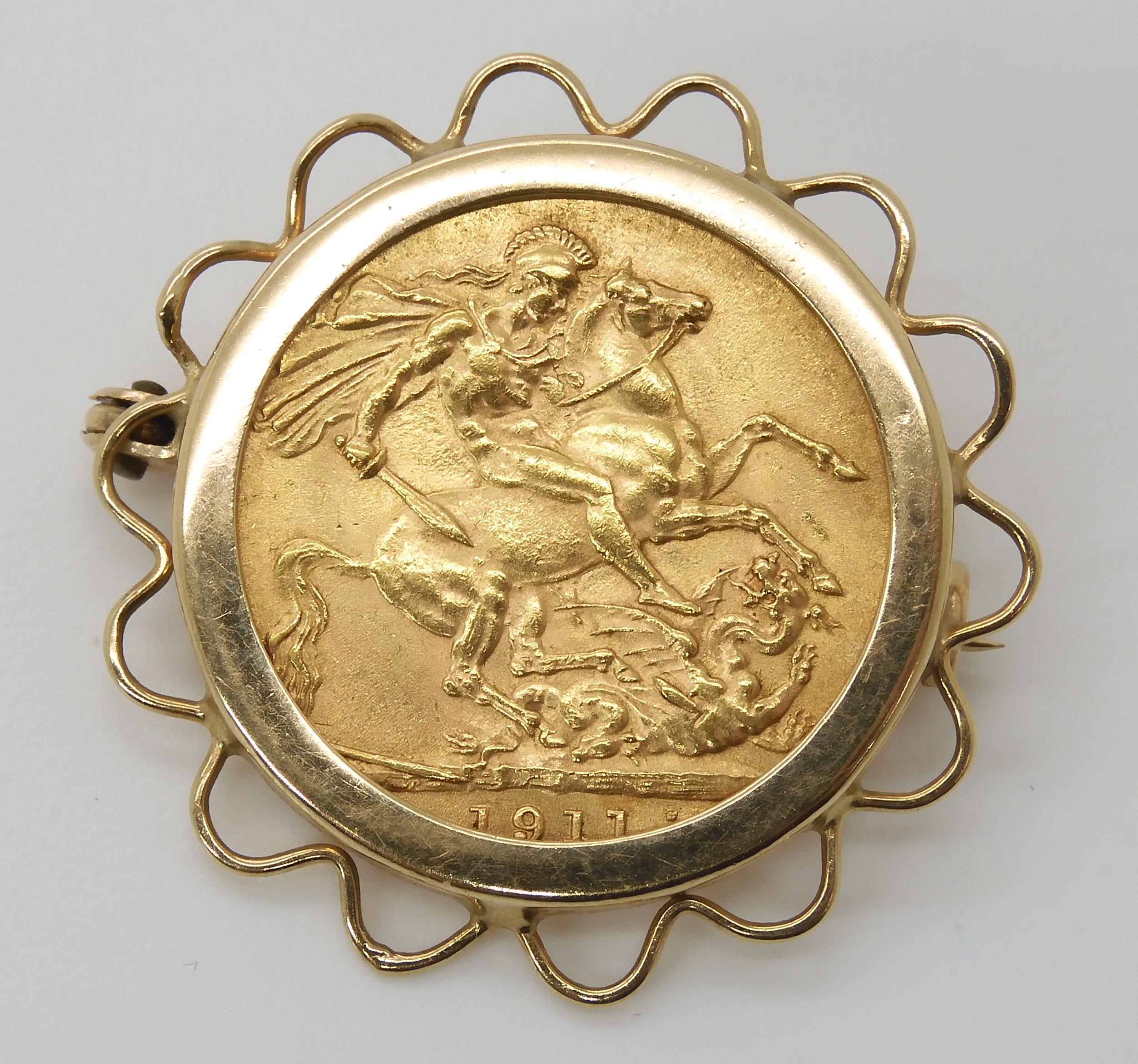 A 1911 gold full sovereign in a 9ct brooch mount, weight 9.7gms Condition Report:Available upon