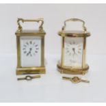 A French brass and glass cased carriage clock, and a Woodford Brass and glass cased oval shaped