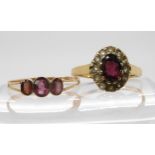 A 9ct gold garnet and clear gem set cluster ring, size N1/2, together with a 9ct gold garnet three