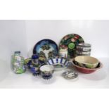 A collection of hand painted Scottish Studio pottery, many decorated with flowers and fruits,