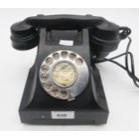 A bakelite telephone in black Condition Report:Available upon request