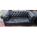 A 20th century black leather button back chesterfield style drop end club settee, 68cm high x