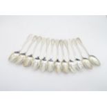 A set of twelve William IV Scottish silver table spoons, in the fiddle and shell pattern, by