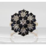 A 9ct gold sapphire and diamond accent flower cluster ring size O1/2, weight 3.4gms Condition