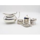 A collection of silver including a continental silver ashtray with relief decoration of figures in a