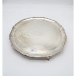 A large George V silver salver, with scalloped rim, with presentation inscription, supported on