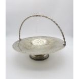 A silver plated swing handled fruit basket, the body engraved with floral vine decoration, with a