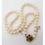 A string of cultured pearls with an unusual 14k gold ruby and sapphire clasp, each pearl approx 6.