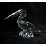 A Daum clear glass model of a pelican perched on a rock, etched mark to base, 22cm high Condition