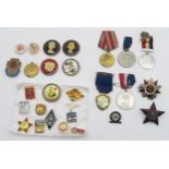 A collection of Soviet style badges, medals etc