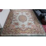 A 20th century light green ground Aubusson style rug with floral central medallion and matching