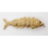 A 9ct large articulated fish pendant, length 8.5cm, weight 25.3gms Condition Report:Available upon