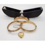 A boxed rolled gold bangle, a 9ct B&F locket and two gold plated bangles Condition Report:Not