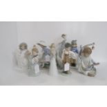 A collection of five Lladro figures including a model of a baby sleeping on a crescent moon, a