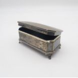 A George V silver jewellery box, of faceted form, velvet lined, on four bracket feet, by Percy James