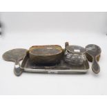 A matched silver mounted tortoiseshell vanity set, comprising tray, box, glass jar, hand mirror,
