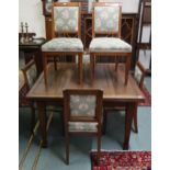 A 20th century mahogany pull out dining table, six upholstered mahogany dining chairs and a mahogany