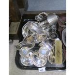 A collection of EPNS including a pair of stamped sterling filled candlesticks, sugar tongs,