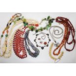 A string of peacock glass beads, amber beads, a white metal Siam Wear necklace and other items