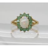 A 9ct gold opal and emerald cluster ring, size O, weight 2.2gms Condition Report:Available upon