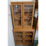 A modern astragal glazed two door cabinet and two accompanying single door cabinets (3) Condition