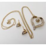 A 9ct gold diamond set heart pendant with matching earrings, weight combined 3.2gms Condition